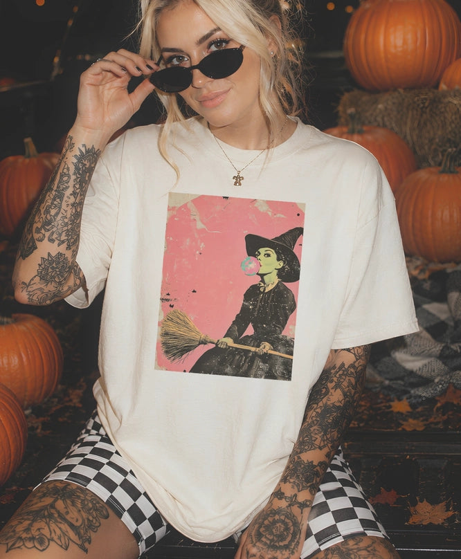 Girl with cream t-shirt witch blowing bubble gum on a broom - retro