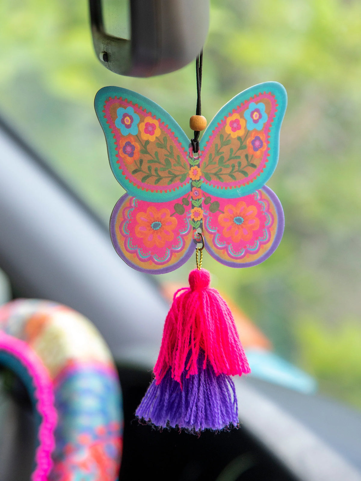 BUTTERFLY AIR FRESHENER HANGING FROM REAR VIEW MIRROR