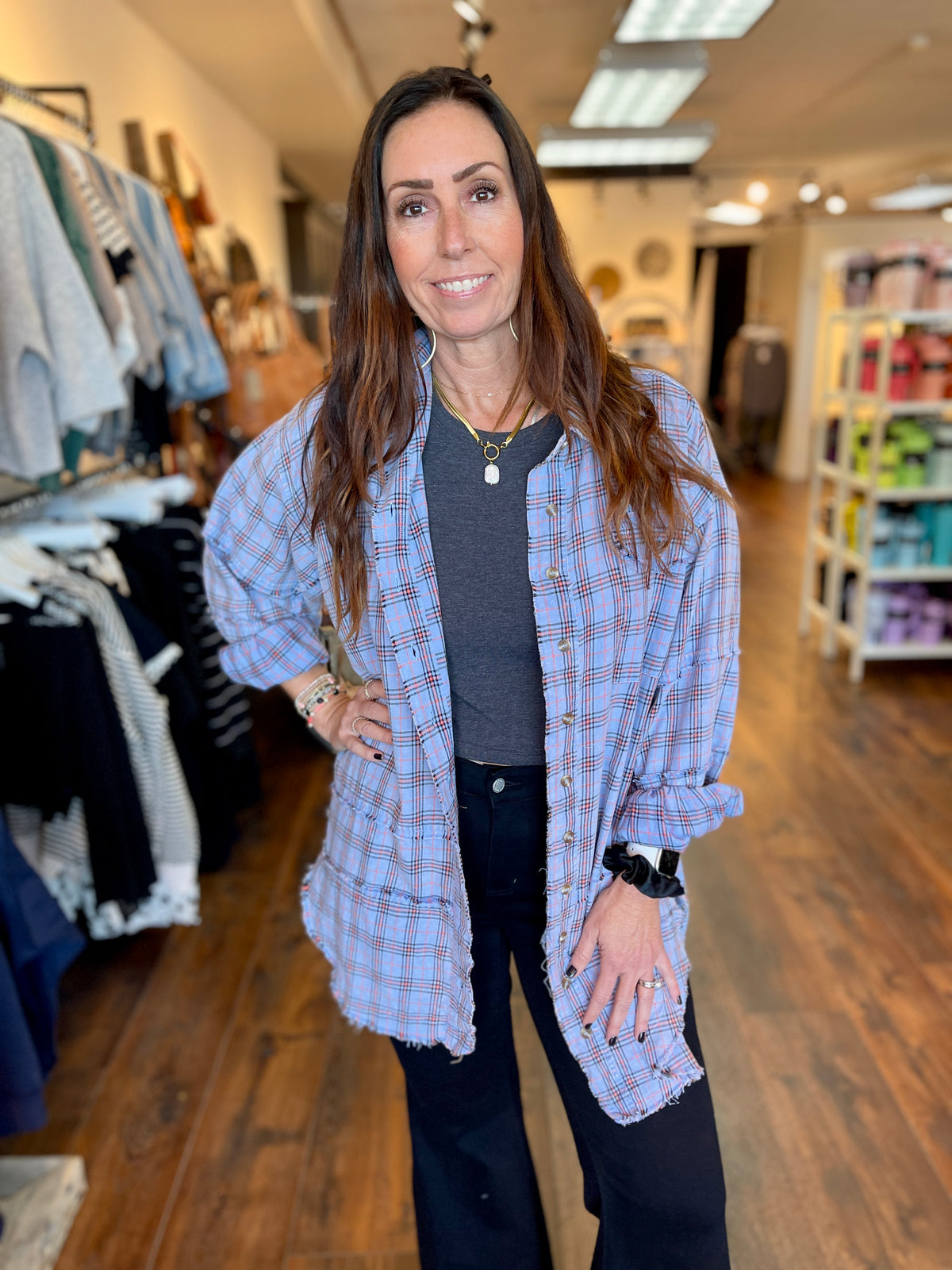 Woman wearing mineral wash blue plaid, button down shirt.