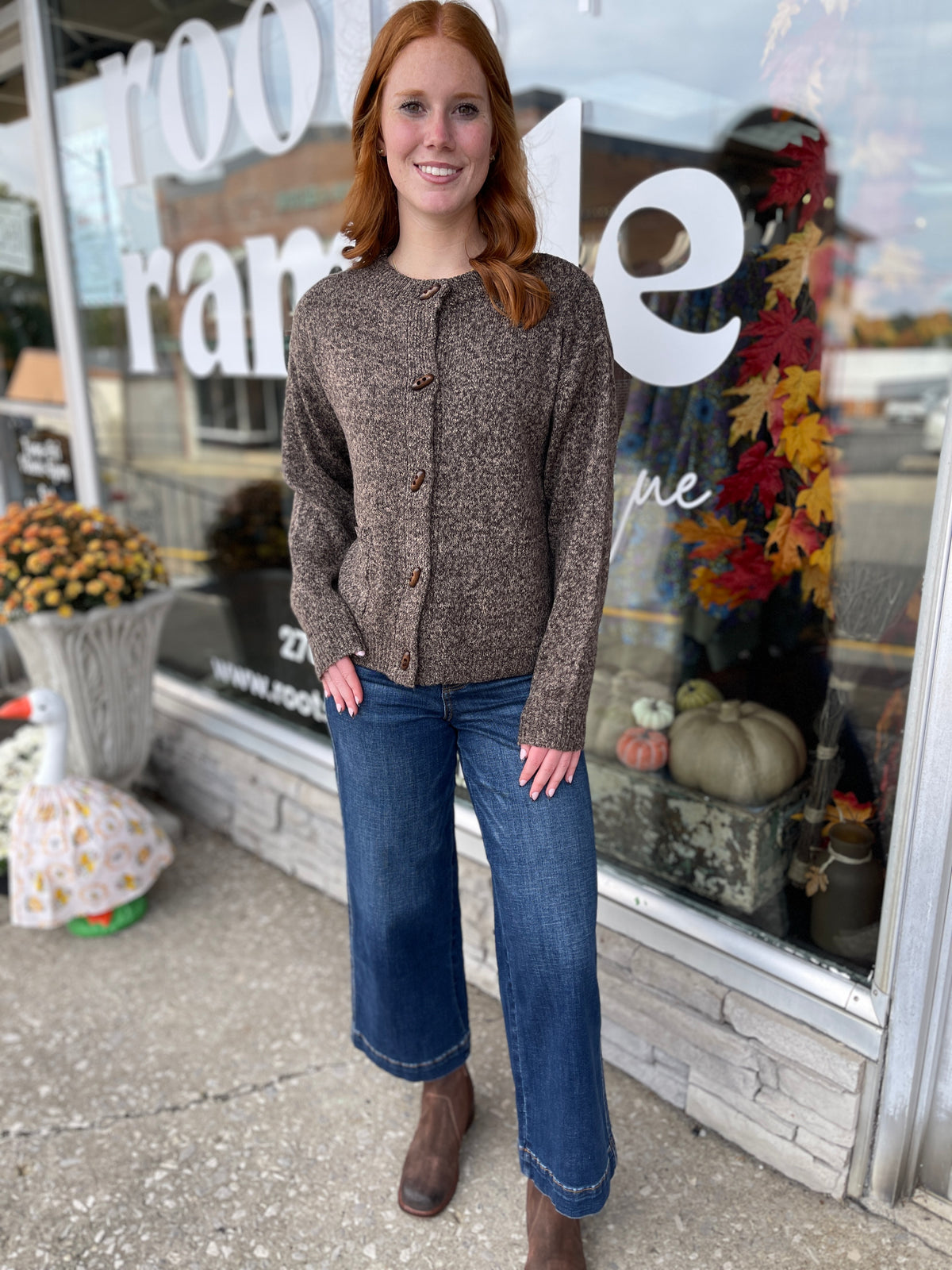 STANDING WOMAN IN A BUTTON DOWN CARDIGAN WITH POCKETS
