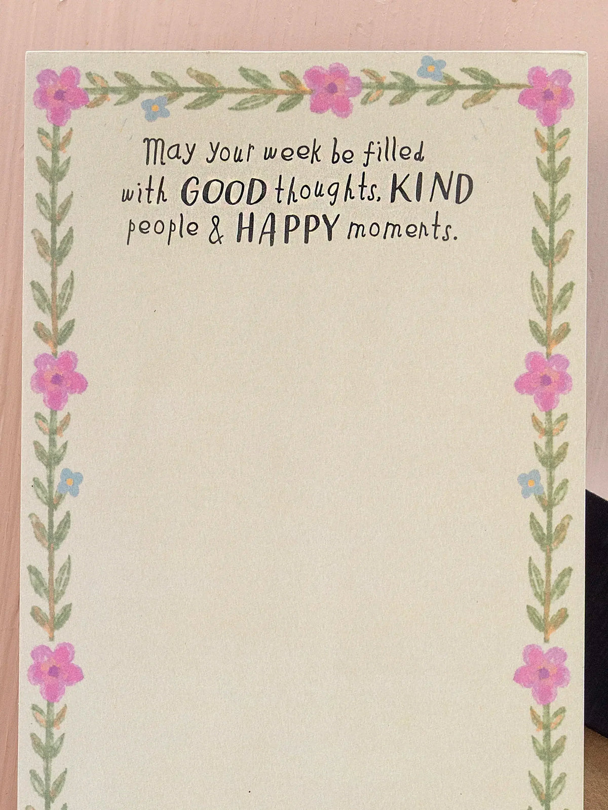 NOTE PAD WITH WORDS ON WOOD BACKGROUND