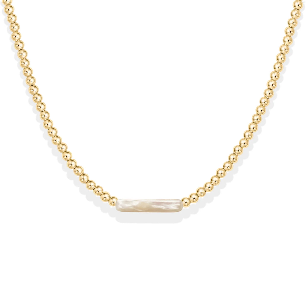 gold beaded necklace with pearl center on white background