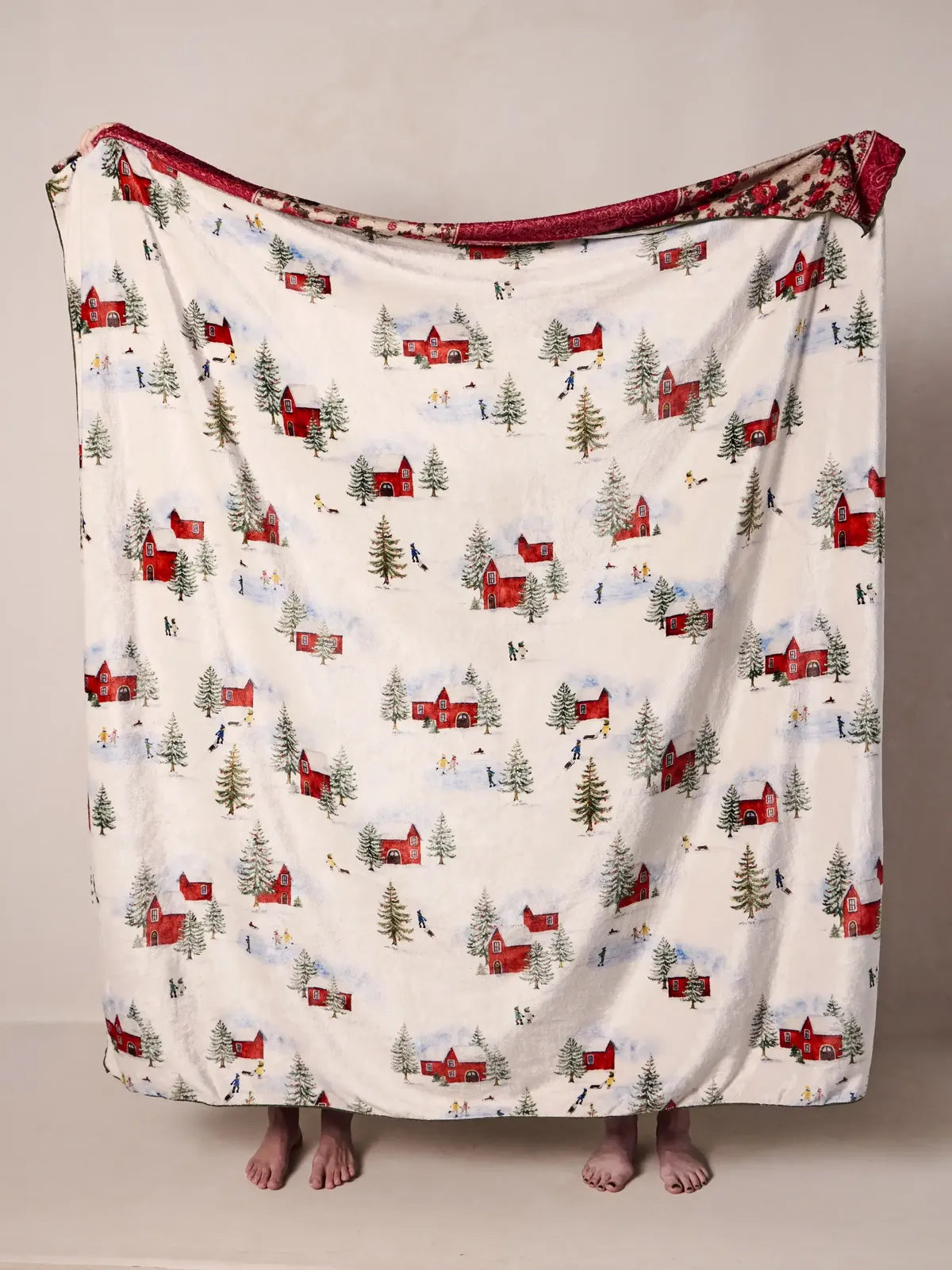 WHITE BLANKET WITH RED BARNS AND EVERGREEN TREES ON A WHITE BACKGROUND