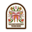 Decorative sticker with a butterfly design and text on a white background