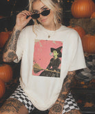 Girl with cream t-shirt witch blowing bubble gum on a broom - retro