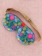Sleep mask with floral colors on a pink background