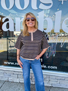 WOMAN IN BLACK AND TAN SHORT SLEEVE SHIRT