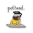 A die-cut sticker featuring a cartoon illustration of a person in a yellow shirt resting their head on a gray table, with a coffee pot over their head and the word 'pothead.' above them.