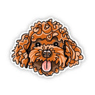A die-cut cartoon dog sticker featuring curly orange-brown fur, black eyes and nose, and a pink tongue sticking out, shown on a plain white background.