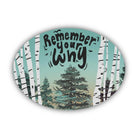 An oval sticker featuring an illustration of birch trees and evergreen trees on a light teal background, with the hand-lettered text 'Remember your why' in black. The item is shown on a clean white background with a soft drop shadow.