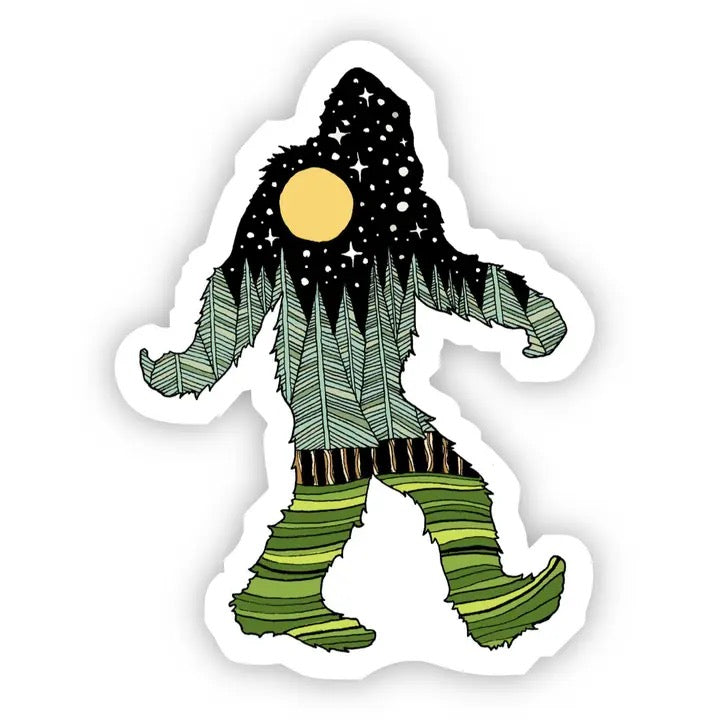 A die-cut sticker featuring a whimsical illustrated Bigfoot-like figure. The figure has a black starry night sky for a head, a round yellow moon, and a forest-patterned body in shades of green and gray, with striped green boots.