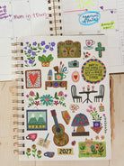 BOOK WITH ENJOY THE LITTLE THINGS ON THE FRONT AND MANY OTHER ICONS