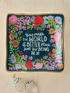 TRINKET DISH WITH FLOWERS AND YOU MAKE THE WORLD A BETTER PLACE JUST BEING IN IT WITH 2 RINGS ON WOOD BACKGROUND