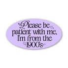 Oval-shaped sticker with text 'Please be patient with me, I'm from the 1900's' on a purple background