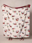 WHITE BLANKET WITH RED BARNS AND EVERGREEN TREES ON A WHITE BACKGROUND
